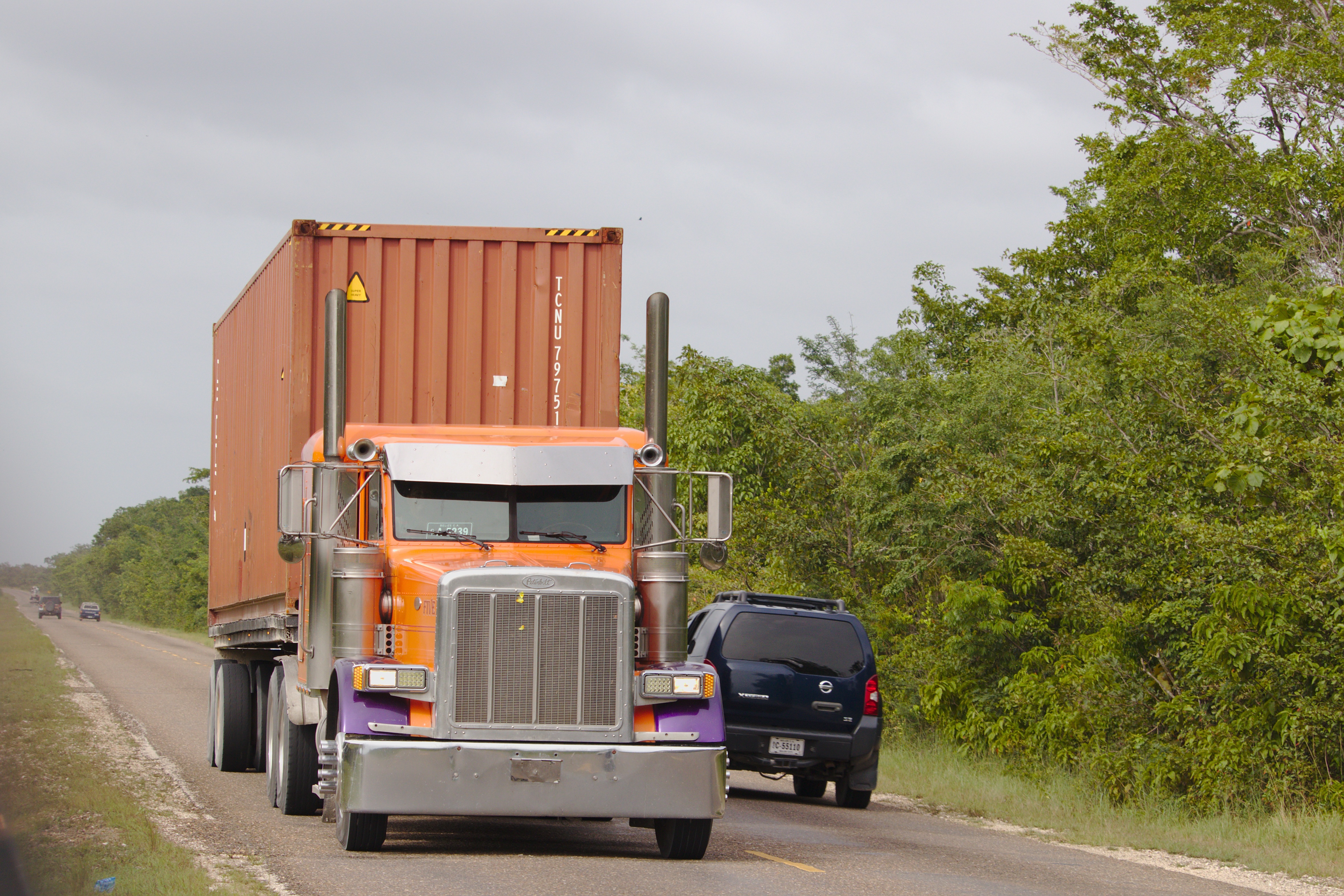 West Africa freight corridor — trucks on highway, cargo transport across ECOWAS region