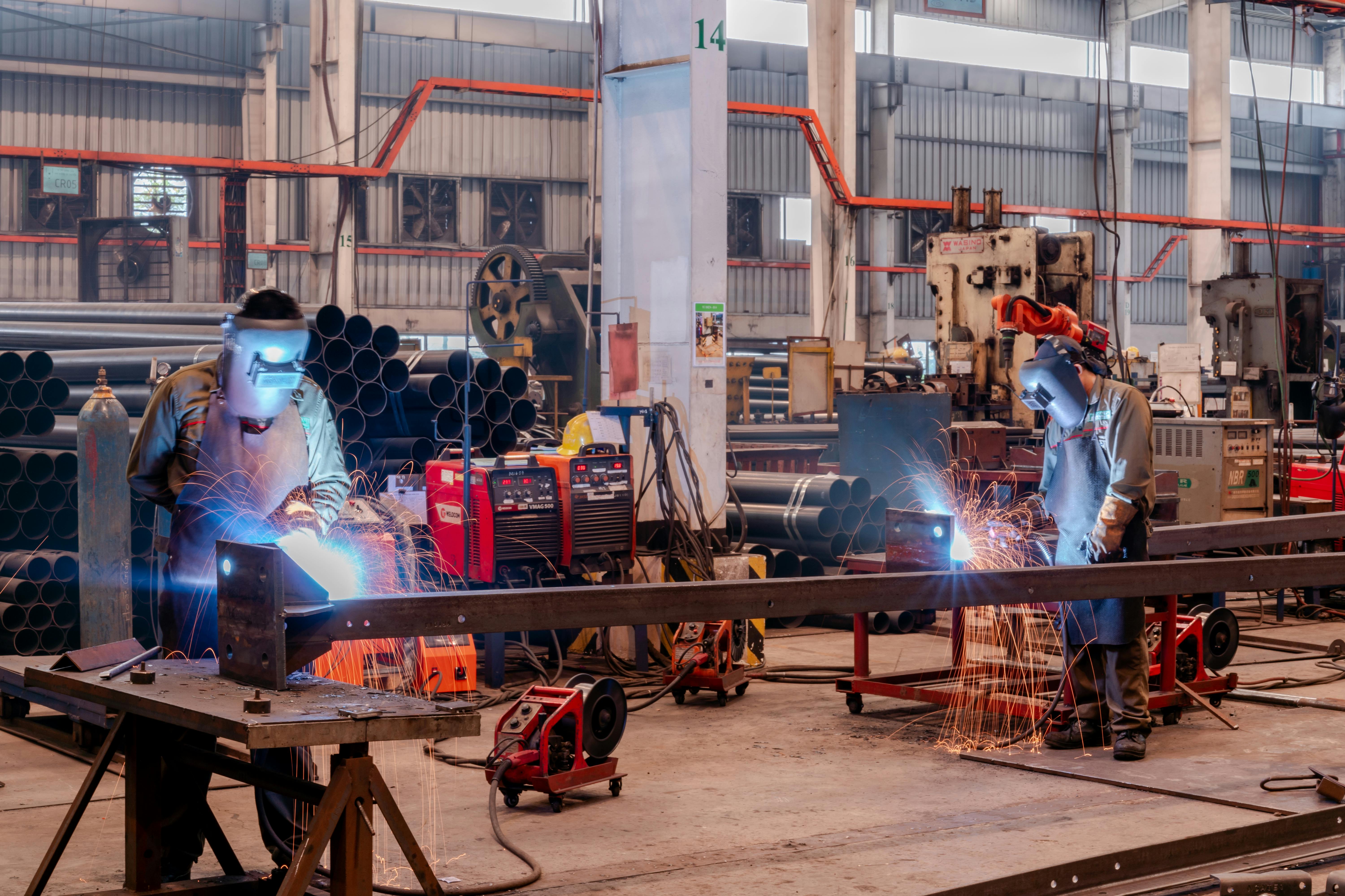Industrial manufacturing facility — factory floor with production equipment and workers