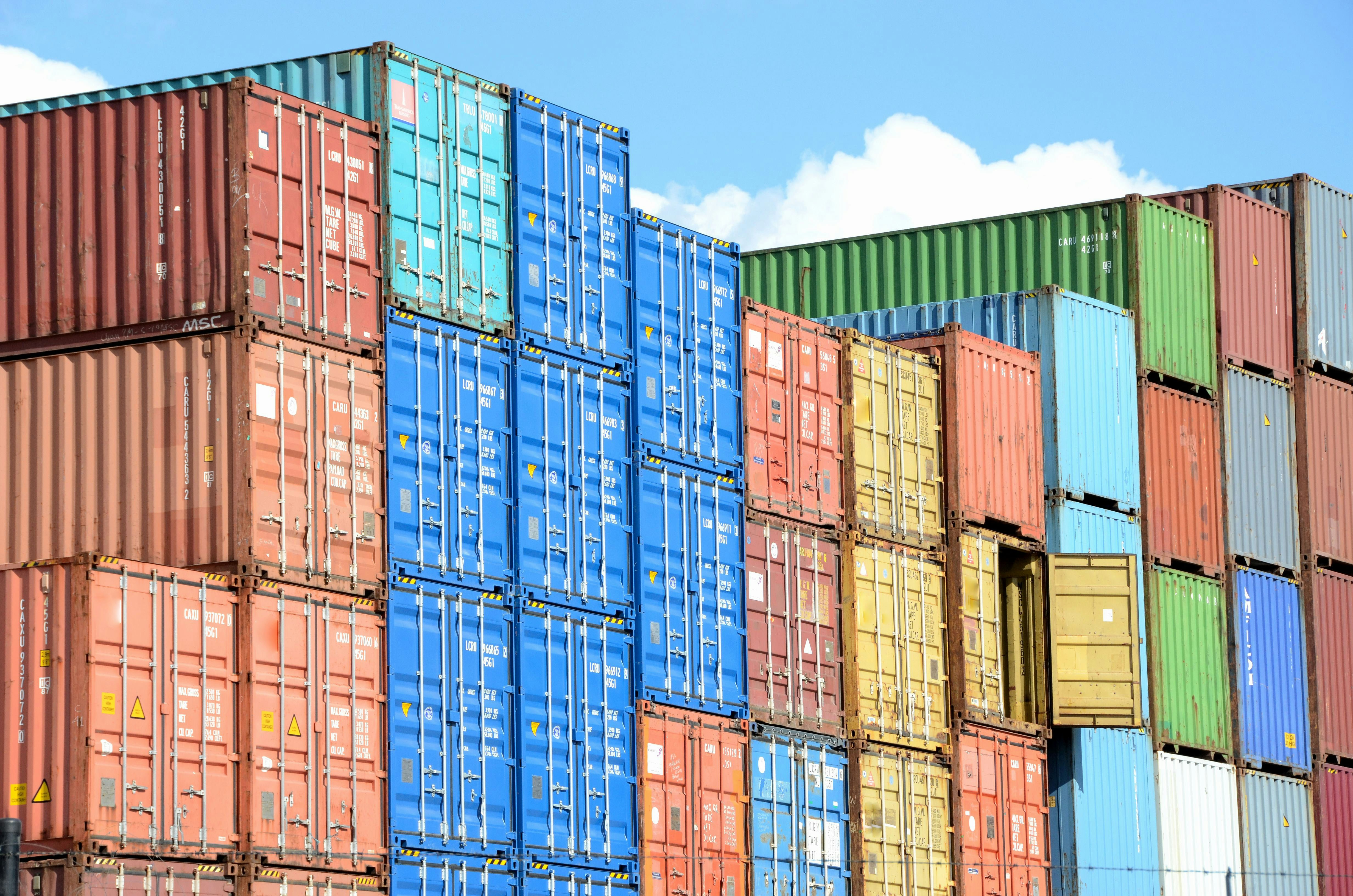 Shipping containers stacked at international port — import and export operations