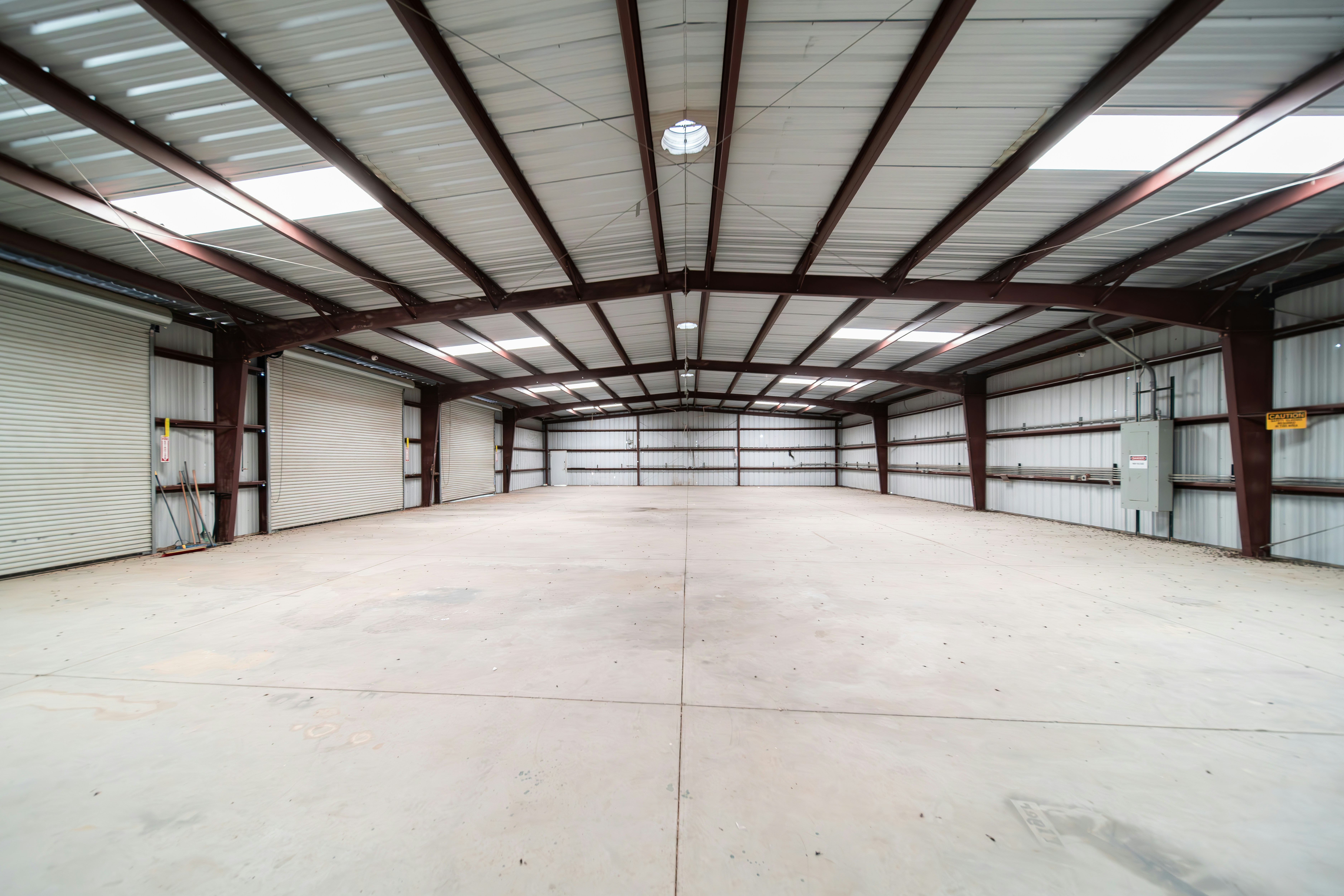 Modern warehouse interior — wide shot showing high bay racking and forklift operations
