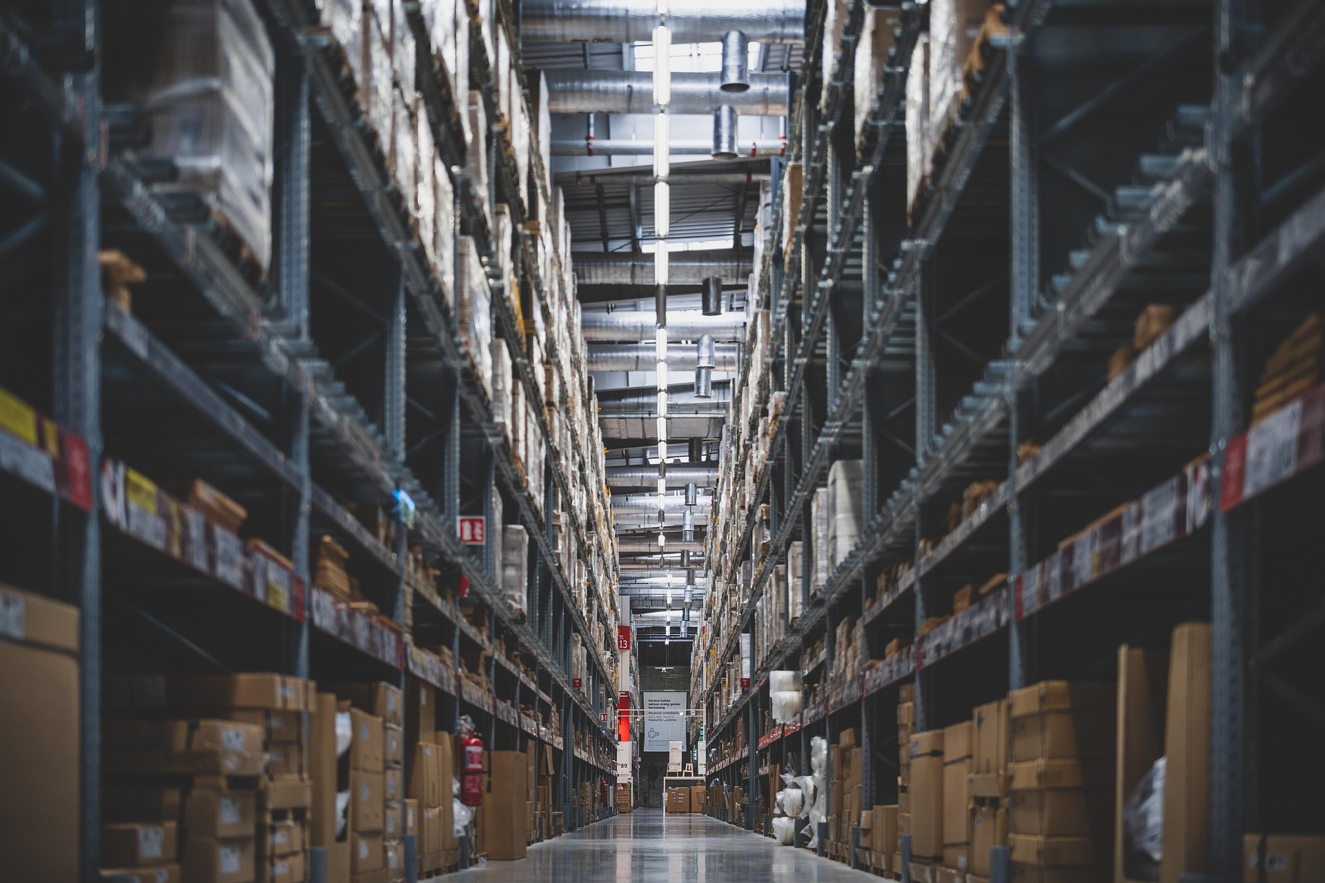 Warehouse aisle with tall metal shelving and organised inventory — professional storage facility interior